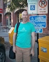 Photo of Campbell MacDonold standing in front of a handicap parking sign