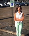 Photo of Kathryn McCarter standing in front of a handicap parking sign