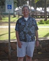 Photo of Michael Stimets standing in front of a handicap parking sign